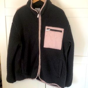 Bark gray fleece jacket with pink pocket, back panel and trim.